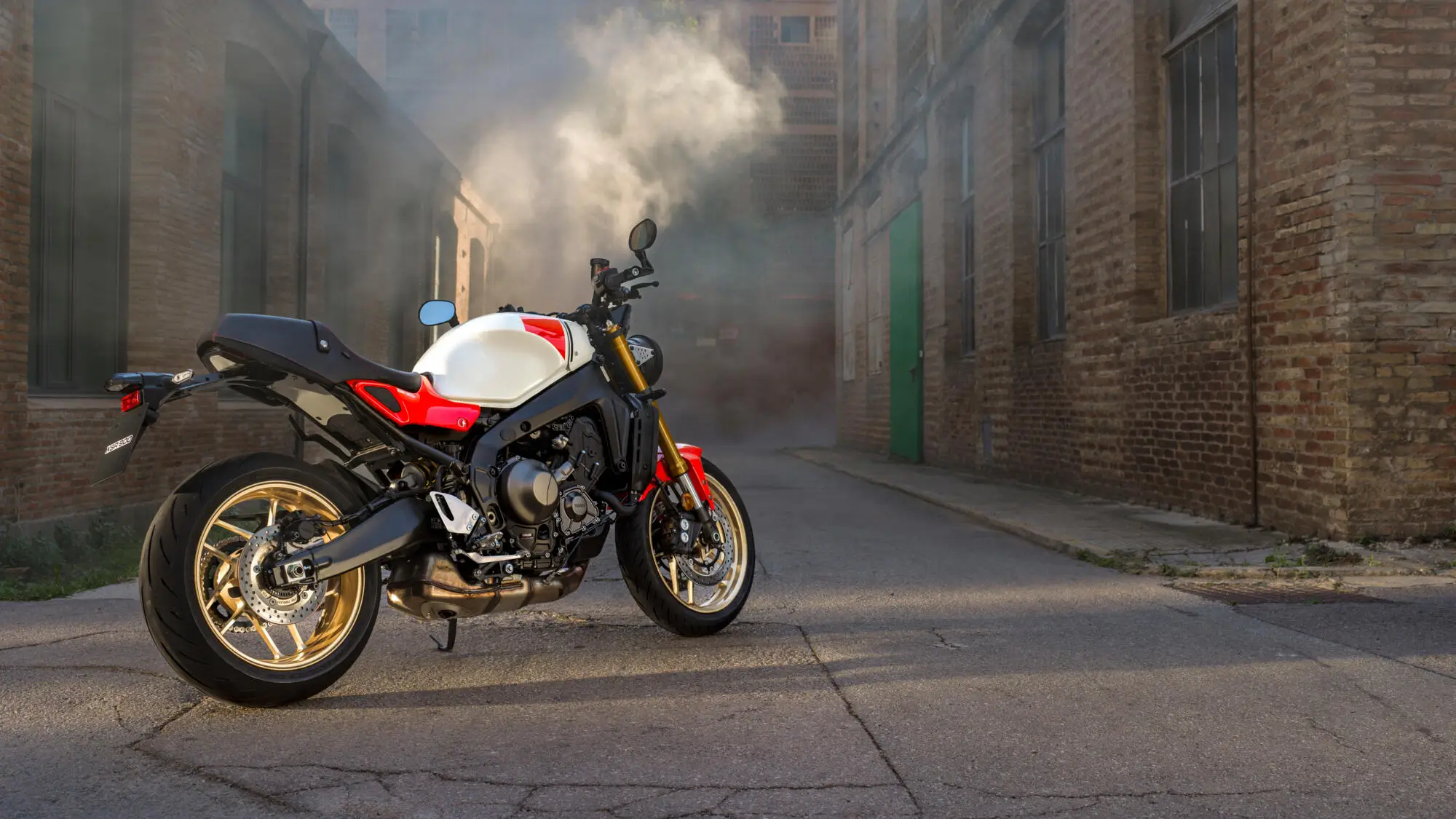 2025-Yamaha-XS850-EU-Legend_Red-Static-008-03 Ein rotes und weißes Yamaha XSR900 Motorrad steht in einer verlassenen Gasse.
