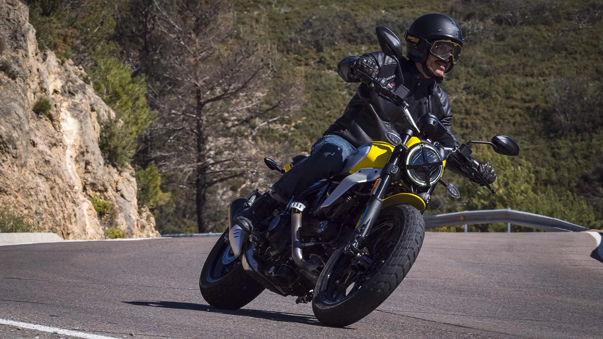 Scrambler-Icon-Next-Gen-riding-gallery-1920x1080-07 Ein Motorradfahrer auf einer Ducati Scrambler Icon fährt eine kurvige Bergstraße entlang.