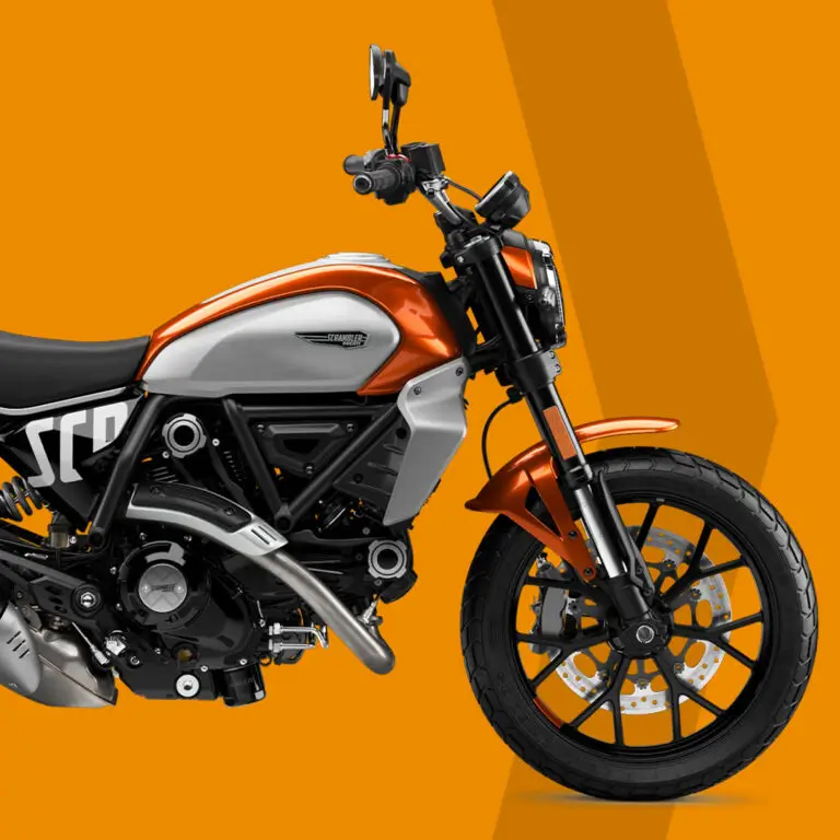 Ein orange-weißer Scrambler-Motorrad auf orangem Hintergrund.
