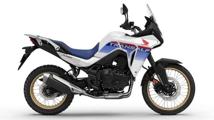 Ein weiß-blaues Honda Transalp Motorrad von der Seite.